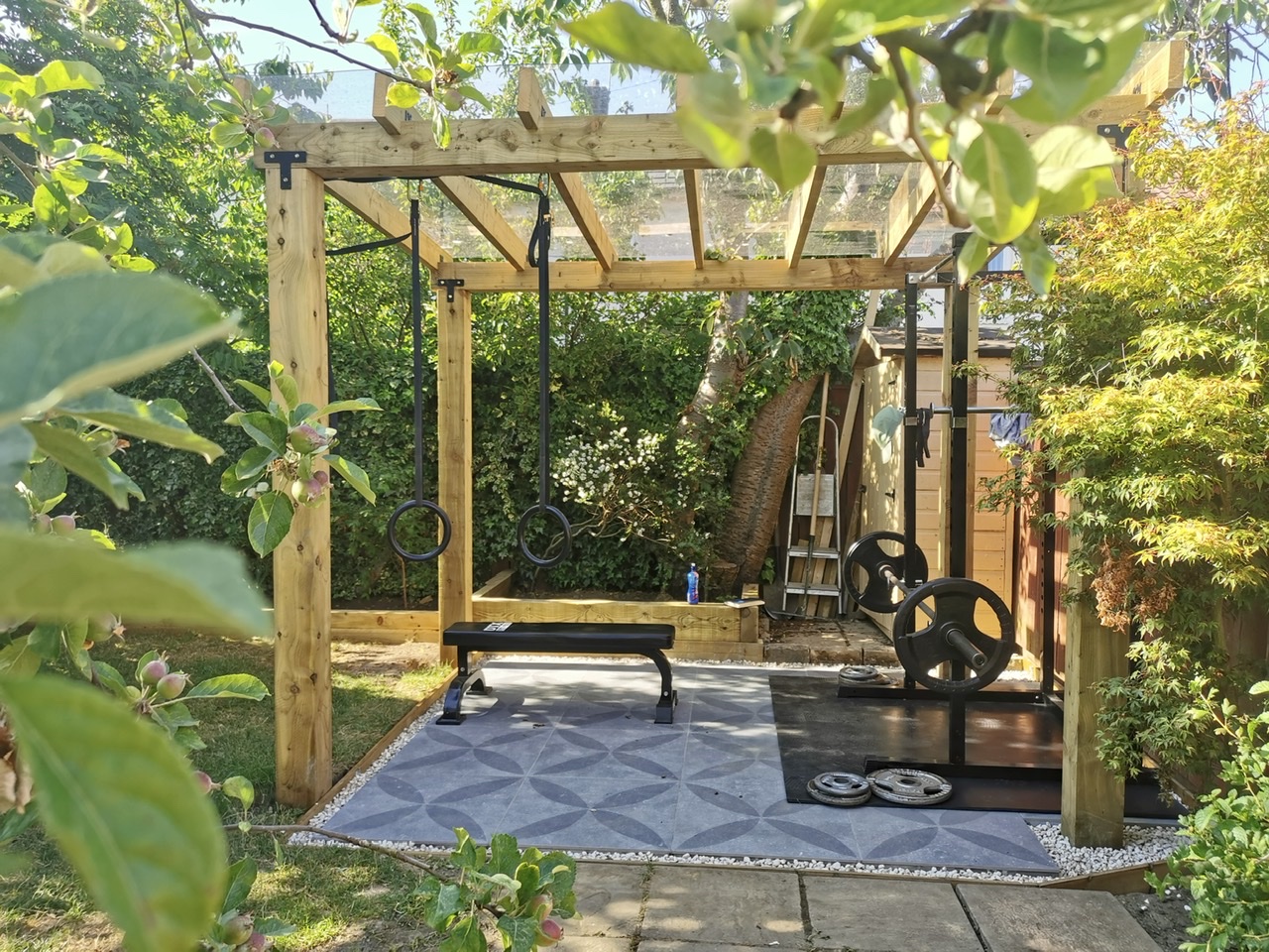 Outdoor garden gym with squat rack and gymnastic rings
